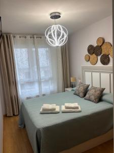 a bedroom with a bed with two towels on it at Maresia in Burela de Cabo