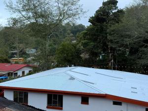 a metal roof on top of a white house at Cumbre Serena by Montea in Empalme +9 photos