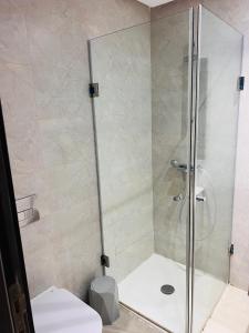 a shower stall in a bathroom with a toilet at Modern Oasis near Airport & Lac 2 - Wahat Aouina in El Aouina Station +2 photos