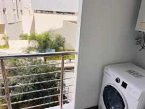 a washing machine in a room with a balcony at Modern Oasis near Airport & Lac 2 - Wahat Aouina in El Aouina Station