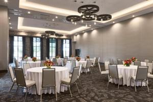a conference room with tables and chairs in a room at Archer Hotel Florham Park in Florham Park +61 photos