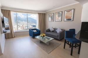 a living room with a couch and a table at Torres de Suites by InAmazonas in Quito