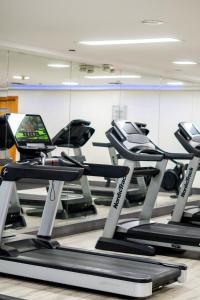 a gym with treadmills and a laptop on a treadmill at Torres de Suites by InAmazonas in Quito