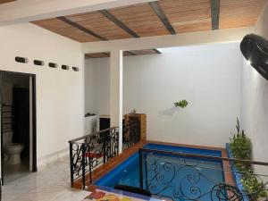 a room with a balcony with a fish tank at Casa Armonia in Honda