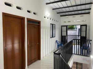 a hallway with two wooden doors and a staircase at Casa Armonia in Honda