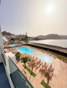 an overhead view of a resort with two pools and chairs at BH Cura marina 2 in Mogán