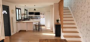 a staircase leading to a kitchen and a living room at Maison au calme in Nogent-sur-Eure