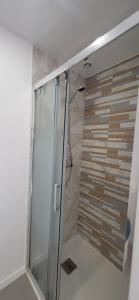 a shower with a glass door in a bathroom at Maison au calme in Nogent-sur-Eure +10 photos