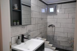 a bathroom with a sink and a mirror at Antel apartment in Naousa
