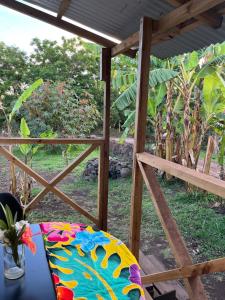 a patio with a table and a colorful pillow at Hospedaje Maika Rapa Nui in Hanga Roa