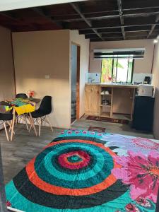 a room with a colorful rug on the floor at Hospedaje Maika Rapa Nui in Hanga Roa