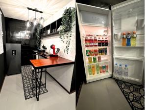 a refrigerator filled with drinks and a table in a kitchen at Hotel Homsty in San Martín Texmelucan de Labastida