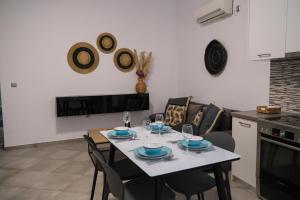 a kitchen and dining room with a table and chairs at Antel apartment in Naousa +14 photos