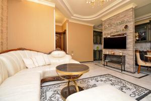 a living room with a white couch and a fireplace at Luxury Apartament in Amiryan Street Nerby Republic Square in Yerevan