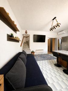 a living room with a couch and a television at Villa Pilgrimos in Ierissos