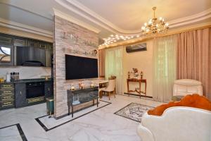 a living room with a fireplace and a tv at Luxury Apartament in Amiryan Street Nerby Republic Square in Yerevan