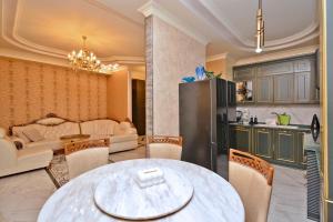 a living room with a table and a kitchen at Luxury Apartament in Amiryan Street Nerby Republic Square in Yerevan +15 photos
