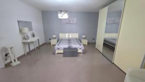 a bedroom with a bed and a mirror at Casa Quattro Cannelli in Pozzuoli