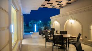 a dining room with tables and chairs on a balcony at TK Royal Hotel & SPA in Hurghada