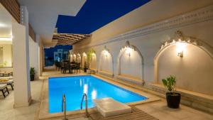a swimming pool in a building with a restaurant at TK Royal Hotel & SPA in Hurghada