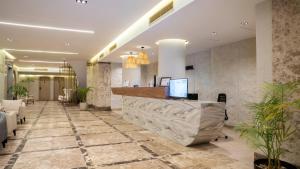 a lobby with a reception desk in a building at TK Royal Hotel & SPA in Hurghada +77 photos