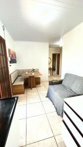 a living room with a couch and a table at Apto na Praia do Cassino in Rio Grande