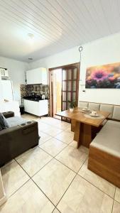 a living room with a couch and a table at Apto na Praia do Cassino in Rio Grande