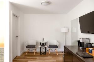 a kitchen with two chairs and a table at Tofino Resort + Marina in Tofino