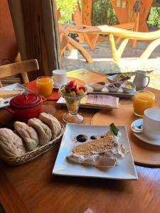 a table with a plate of food and bread at Casa Bosque Lodge in San José de Maipo