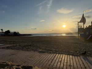 a sunset on a beach with a lifeguard station at costa blanca marbella in Marbella