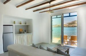 a living room with a couch and a view of the ocean at Thavma Beach House in Mytakas