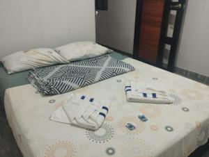 two beds with towels sitting on top of them at CASA HOTEL EL PRADo in Mesetas