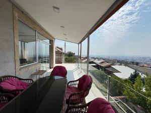 a balcony with chairs and tables on a building at Villa in Norq -Marash in Yerevan