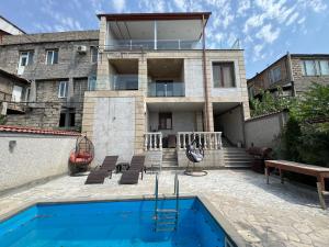 a house with a swimming pool in front of a building at Villa in Norq -Marash in Yerevan