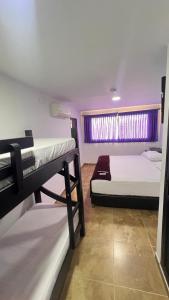 a room with two bunk beds and a window at Hotel Tayromar in Santa Marta