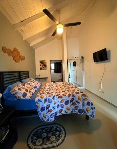 a bedroom with a bed and a ceiling fan at Casa MIA in Cabarete