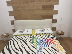 a bedroom with a zebra print bed with two pillows at Camera vicino Ospedale Maggiore, Concerti e Aeroporto Bologna 60 mq in Bologna +11 photos