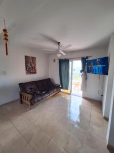 a living room with a couch and a ceiling fan at Complejo la Superiora in Villa Krause