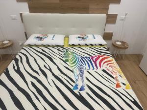 a bedroom with a zebra print on a bed at Camera vicino Ospedale Maggiore, Concerti e Aeroporto Bologna 60 mq in Bologna