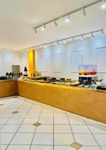 a kitchen with a counter with food on it at Hotel Ze Maria Cambui in Cambuí