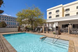 a swimming pool in front of a building at Candlewood Suites Mobile-Downtown by IHG in Mobile
