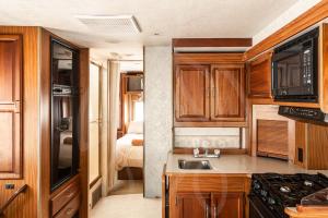 a small kitchen with a sink and a bedroom at MUUN experience in Ciudad del Carmen