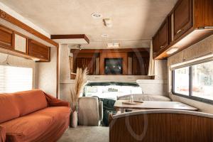 an interior of an rv with a couch and a table at MUUN experience in Ciudad del Carmen