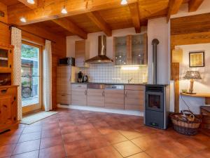 a large kitchen with wooden ceilings and a stove at Lisa in Piesendorf