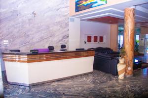 a lobby with a reception desk in a building at NI-FUR Hotel Cotonou in Cotonou +44 photos