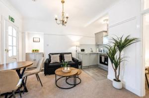 a living room with a couch and a table at Coastal Nest - Cosy flat in Irvine town centre - 5 minute drive from beach in Irvine