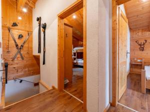 a hallway in a cabin with wooden walls and a door at Lisa in Piesendorf