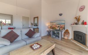 a living room with a couch and a fireplace at Vila Vista Luz in Lagos