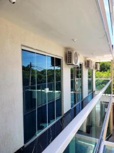 a view from the top floor of a building with glass windows at Terraço Hostel in Cabo Frio