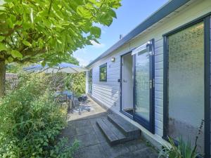 a house with a door and a patio at Chalet Sea Birds in Goedereede